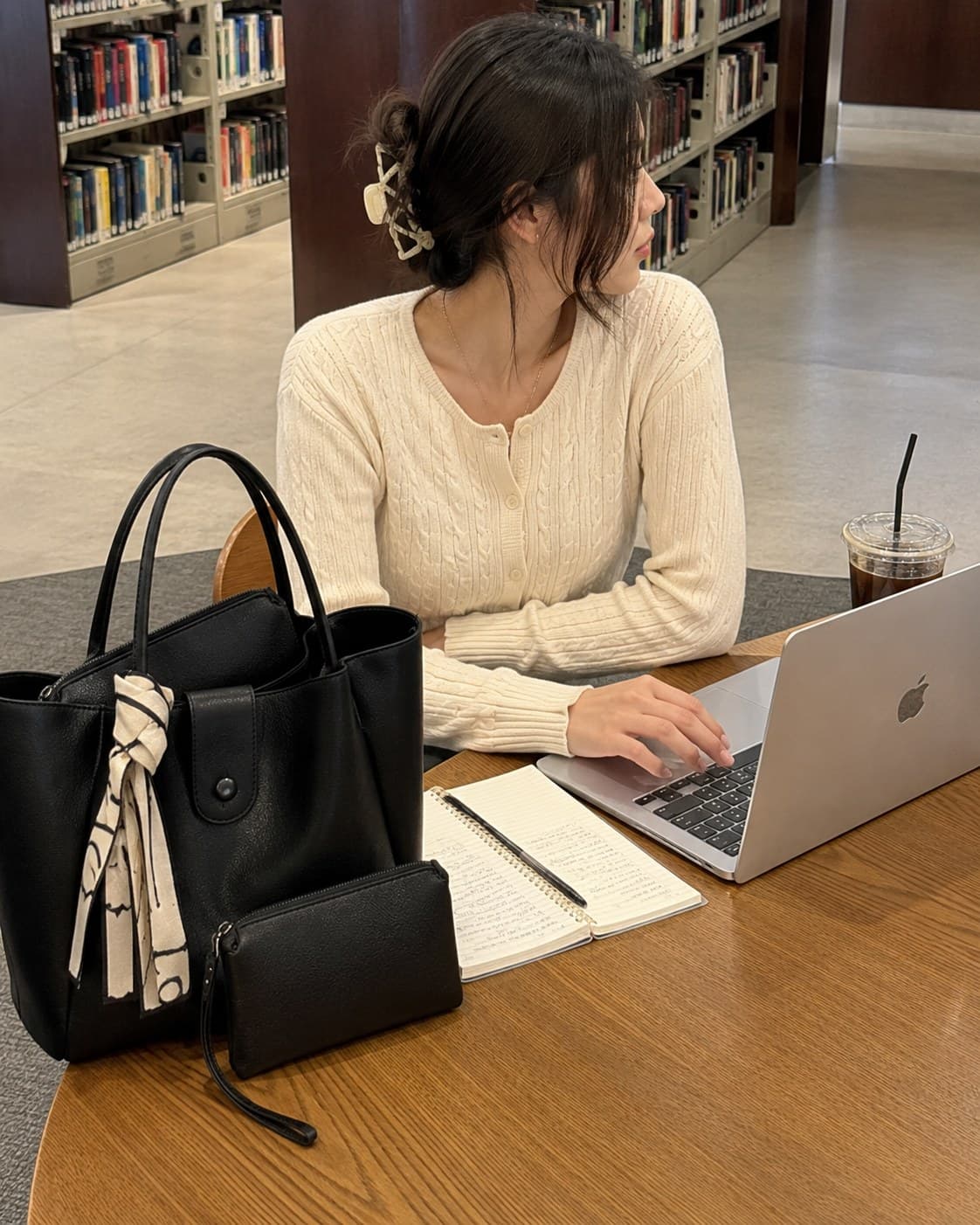 The Everyday Tote in Noir at a library desk